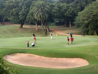 People play golf inside a golf course in Kolkata, India, on November 3, 2024. (