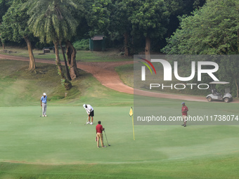 People play golf inside a golf course in Kolkata, India, on November 3, 2024. (