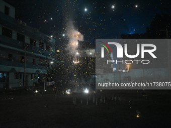 People enjoy a fireworks show in Kolkata, India, on November 3, 2024. (