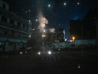 People enjoy a fireworks show in Kolkata, India, on November 3, 2024. (