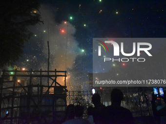 People enjoy a fireworks show in Kolkata, India, on November 3, 2024. (