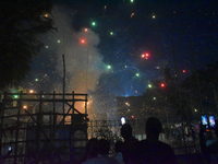 People enjoy a fireworks show in Kolkata, India, on November 3, 2024. (