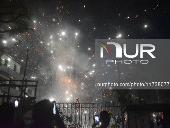 People enjoy a fireworks show in Kolkata, India, on November 3, 2024. (