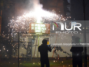 People enjoy a fireworks show in Kolkata, India, on November 3, 2024. (