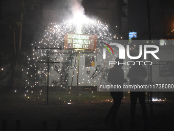 People enjoy a fireworks show in Kolkata, India, on November 3, 2024. (