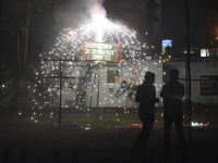 People enjoy a fireworks show in Kolkata, India, on November 3, 2024. (