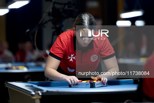 Ana Thomas from the Malta Blackball ladies national team prepares the balls rack before one of the events at the inaugural IBF World Blackba...