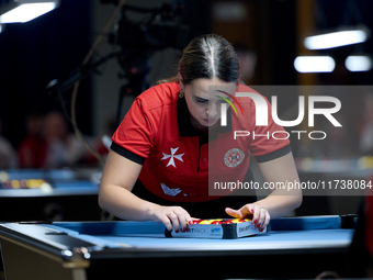 Ana Thomas from the Malta Blackball ladies national team prepares the balls rack before one of the events at the inaugural IBF World Blackba...