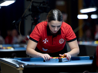 Ana Thomas from the Malta Blackball ladies national team prepares the balls rack before one of the events at the inaugural IBF World Blackba...