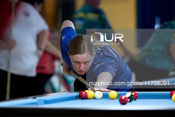 A participant from the Scotland Eightball Pool Federation ladies team performs during one of the events from the inaugural IBF World Blackba...