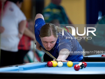 A participant from the Scotland Eightball Pool Federation ladies team performs during one of the events from the inaugural IBF World Blackba...