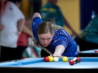 A participant from the Scotland Eightball Pool Federation ladies team performs during one of the events from the inaugural IBF World Blackba...