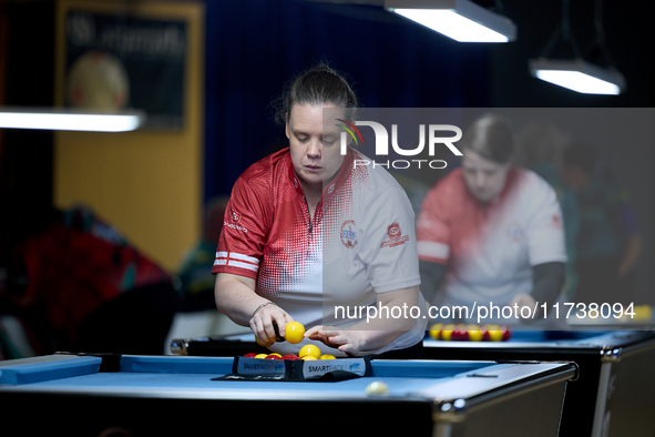 A female blackball player from the English Blackball Pool Federation ladies national team prepares the rack of balls before one of the event...