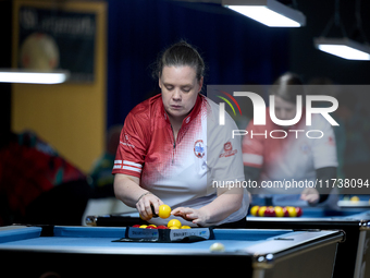 A female blackball player from the English Blackball Pool Federation ladies national team prepares the rack of balls before one of the event...