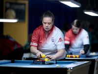 A female blackball player from the English Blackball Pool Federation ladies national team prepares the rack of balls before one of the event...