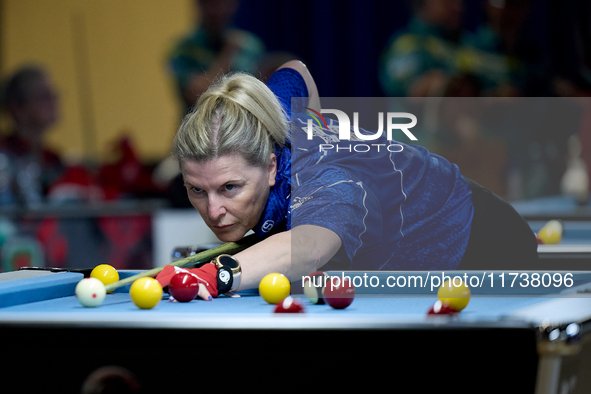 A participant from the Scotland Eightball Pool Federation ladies team performs during one of the events from the inaugural IBF World Blackba...