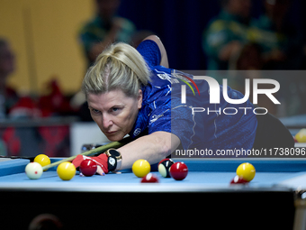 A participant from the Scotland Eightball Pool Federation ladies team performs during one of the events from the inaugural IBF World Blackba...