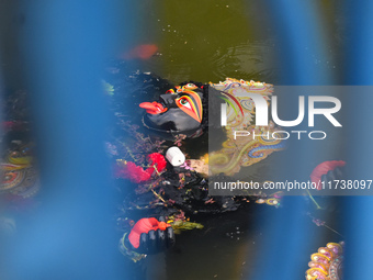 An idol of the Hindu goddess Kali floats after being immersed in a pond in Kolkata, India, on November 3, 2024. (