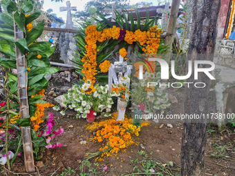 A grave is decorated with marigold flowers at Cemetery del Carmen, in the community of San Miguel Tzinacapan, during the Mexican Day of the...