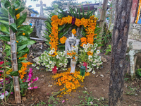 A grave is decorated with marigold flowers at Cemetery del Carmen, in the community of San Miguel Tzinacapan, during the Mexican Day of the...