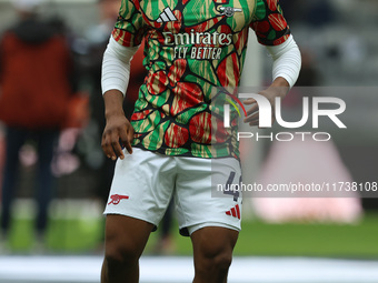 Arsenal's Myles Lewis-Skelly warms up during the Premier League match between Newcastle United and Arsenal at St. James's Park in Newcastle,...