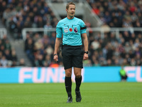 Match referee John Brooks officiates during the Premier League match between Newcastle United and Arsenal at St. James's Park in Newcastle,...