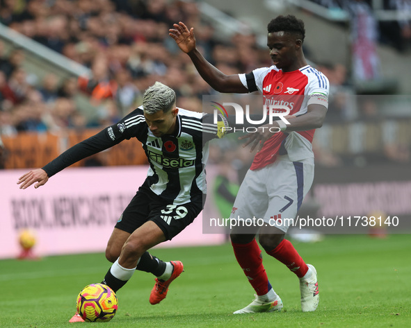 Bruno Guimaraes of Newcastle United battles with Bukayo Saka of Arsenal during the Premier League match between Newcastle United and Arsenal...