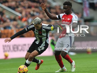 Bruno Guimaraes of Newcastle United battles with Bukayo Saka of Arsenal during the Premier League match between Newcastle United and Arsenal...