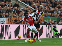 Arsenal's Bukayo Saka battles for possession with Newcastle United's Joelinton during the Premier League match between Newcastle United and...