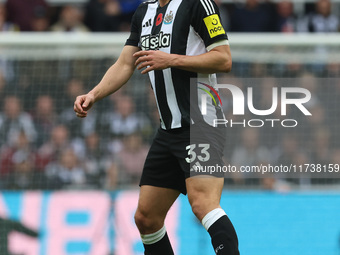 Dan Burn of Newcastle United participates in the Premier League match between Newcastle United and Arsenal at St. James's Park in Newcastle,...