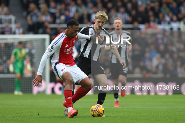 Arsenal's Gabriel dispossesses Newcastle United's Anthony Gordon during the Premier League match between Newcastle United and Arsenal at St....