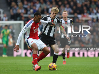 Arsenal's Gabriel dispossesses Newcastle United's Anthony Gordon during the Premier League match between Newcastle United and Arsenal at St....