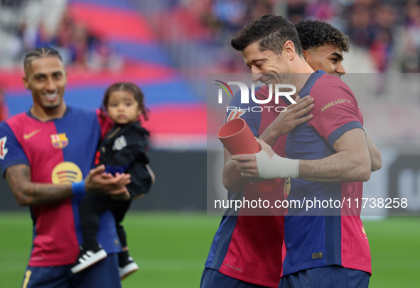 Lamine Yamal gives Robert Lewandowski the MVP of the month of October EA Sports LaLiga award before the match between FC Barcelona and RCD E...