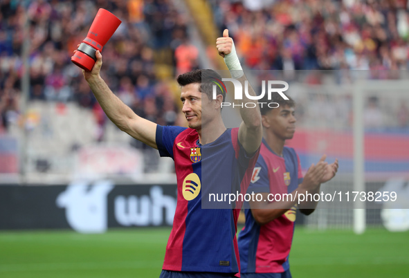 Robert Lewandowski holds the MVP trophy for the month of October before the match between FC Barcelona and RCD Espanyol, corresponding to we...