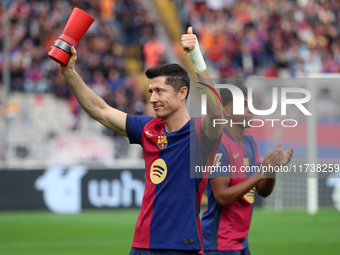 Robert Lewandowski holds the MVP trophy for the month of October before the match between FC Barcelona and RCD Espanyol, corresponding to we...