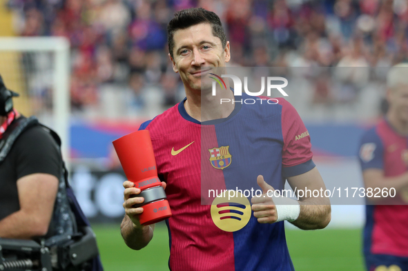 Robert Lewandowski holds the MVP trophy for the month of October before the match between FC Barcelona and RCD Espanyol, corresponding to we...