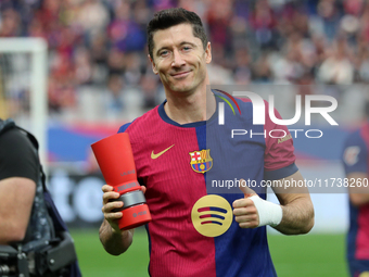 Robert Lewandowski holds the MVP trophy for the month of October before the match between FC Barcelona and RCD Espanyol, corresponding to we...