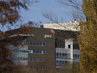 The logo of the accounting firm PricewaterhouseCoopers (PwC) is on the top of a building in Warsaw, Poland, on November 3, 2024. (