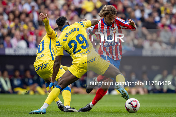 Antoine Griezmann of Atletico de Madrid (right) is in action with the ball against Dario Essugo of UD Las Palmas (left) during the La Liga E...