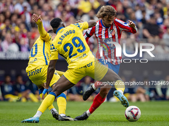 Antoine Griezmann of Atletico de Madrid (right) is in action with the ball against Dario Essugo of UD Las Palmas (left) during the La Liga E...