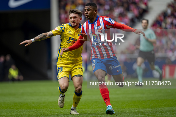 Samuel Lino of Atletico de Madrid (R) is in action against Victor Alvarez Rozada (Viti) of UD Las Palmas (L) during the La Liga EA Sports 20...