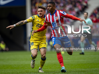 Samuel Lino of Atletico de Madrid (R) is in action against Victor Alvarez Rozada (Viti) of UD Las Palmas (L) during the La Liga EA Sports 20...