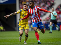 Samuel Lino of Atletico de Madrid (R) is in action against Victor Alvarez Rozada (Viti) of UD Las Palmas (L) during the La Liga EA Sports 20...