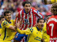 Jose Gimenez of Atletico de Madrid (C) fights for the ball against Alex Munoz (L) and Jose Gomez Campana (R) of UD Las Palmas during the La...