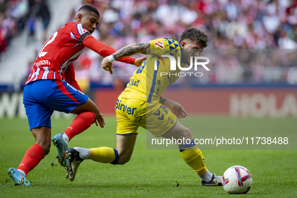 Victor Alvarez Rozada (Viti) of UD Las Palmas competes for the ball against Samuel Lino of Atletico de Madrid during the La Liga EA Sports 2...