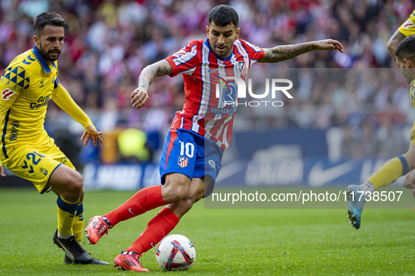 Angel Correa of Atletico de Madrid is in action with the ball during the La Liga EA Sports 2024/25 football match between Atletico de Madrid...