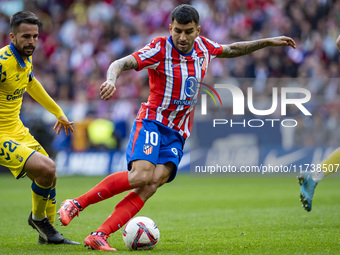 Angel Correa of Atletico de Madrid is in action with the ball during the La Liga EA Sports 2024/25 football match between Atletico de Madrid...