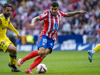 Angel Correa of Atletico de Madrid is in action with the ball during the La Liga EA Sports 2024/25 football match between Atletico de Madrid...