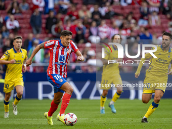 Nahuel Molina of Atletico de Madrid is in action with the ball among players of UD Las Palmas (from L to R) Alberto Moleiro, Fabio Silva, an...