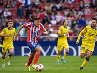 Nahuel Molina of Atletico de Madrid is in action with the ball among players of UD Las Palmas (from L to R) Alberto Moleiro, Fabio Silva, an...